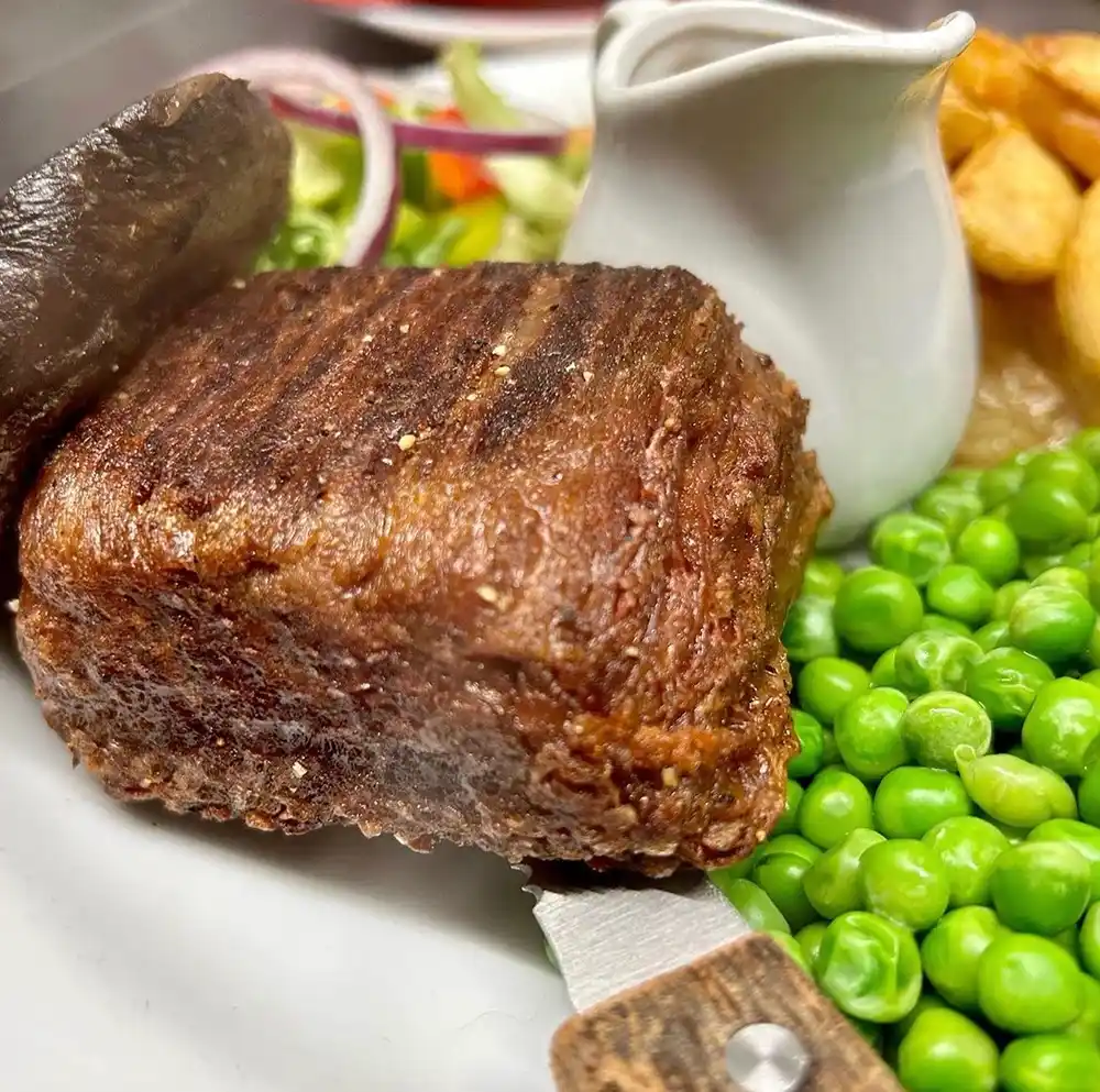 Plant-based steak and peas