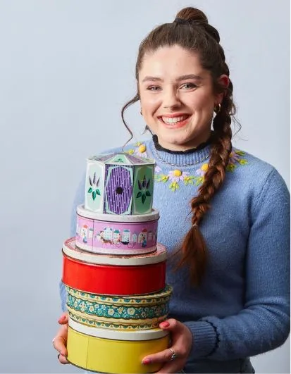 Freya Cox holding a cake